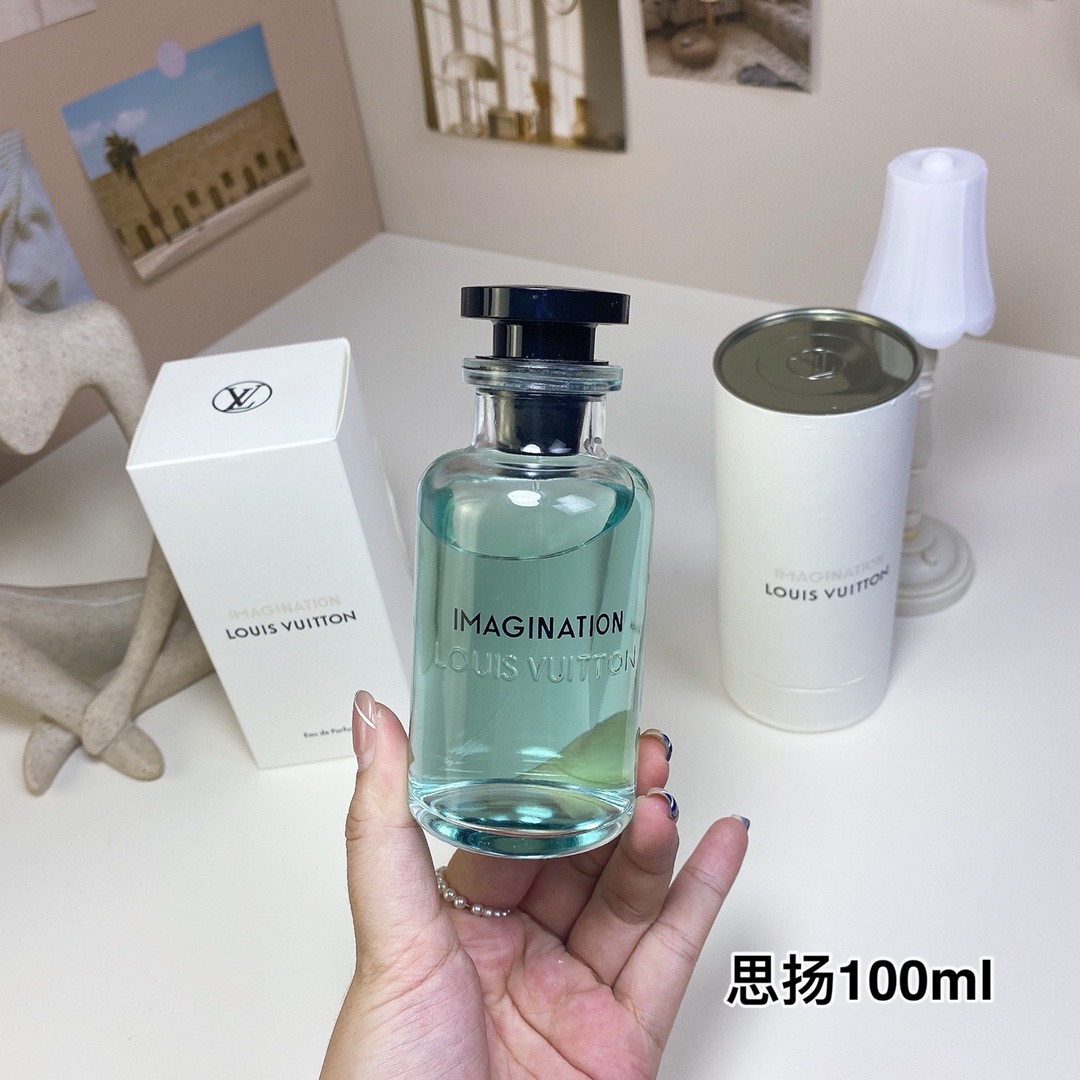 Perfume bottle held in a hand with its box and cylindrical case — US-007 — Catalogue name: Louis Vuitton Imagination — Capacity shown: 100 ml